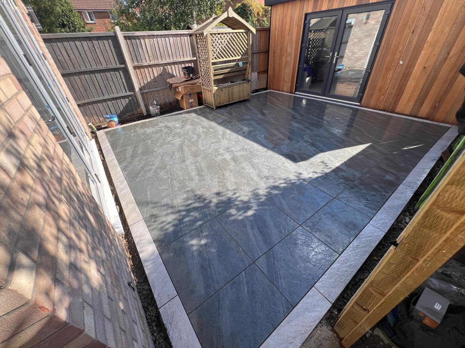 Completed grey porcelain patio by Ciampa and Sons