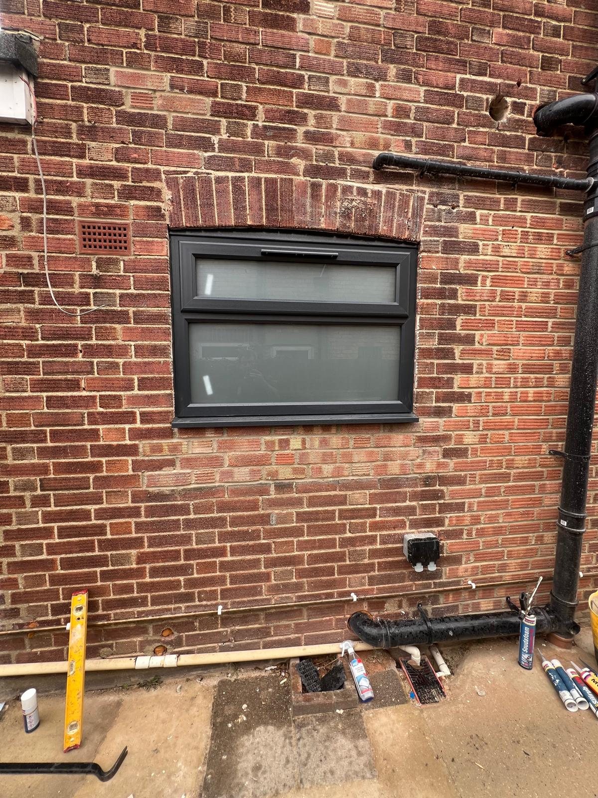 New dark framed window fitted into brickwork